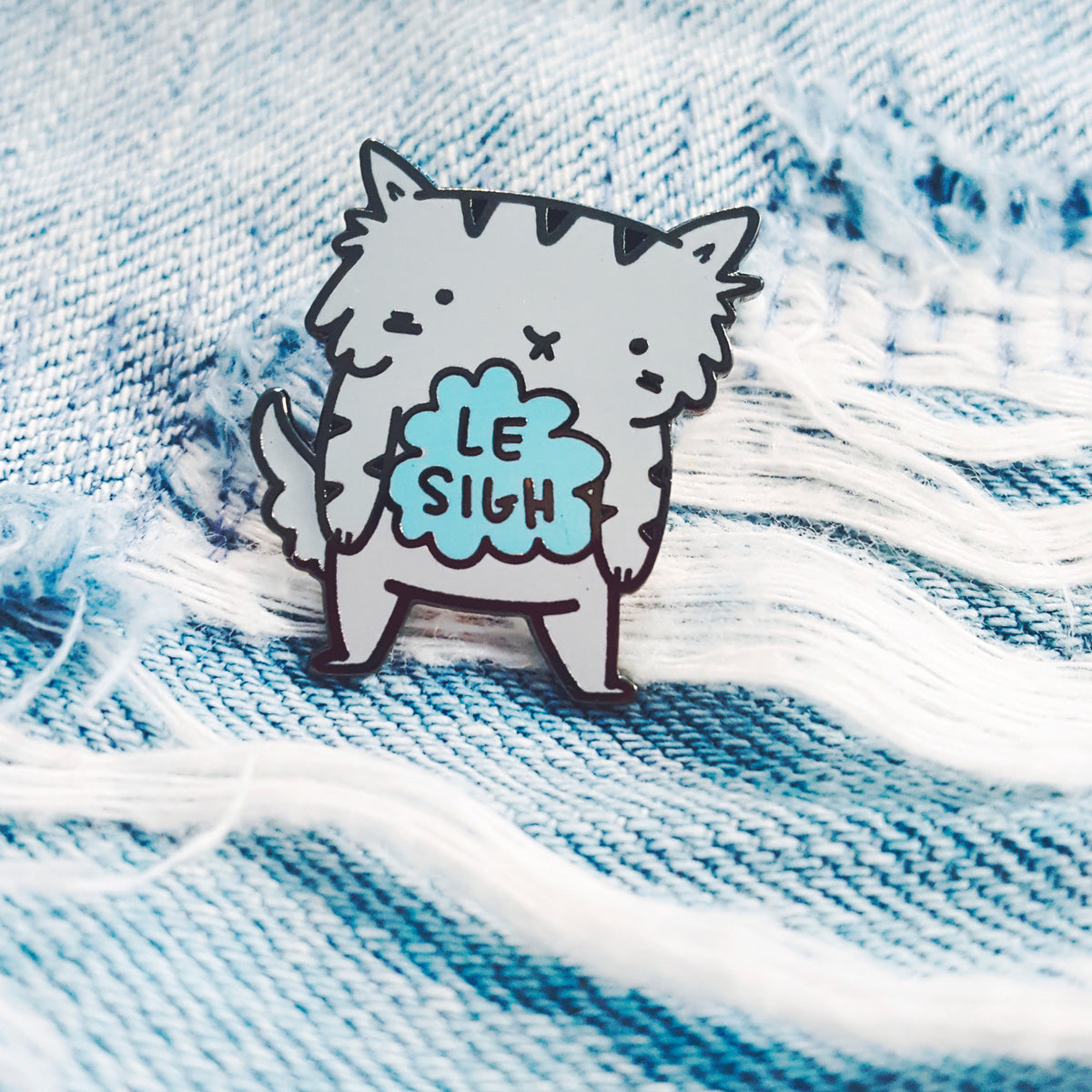 Le Sigh - Enamel pin of a little grey cat who has a bit of a sad storm cloud inside of him.